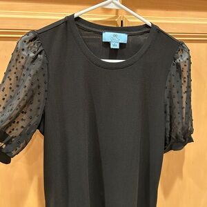 Black top with polka dot sheer sleeves